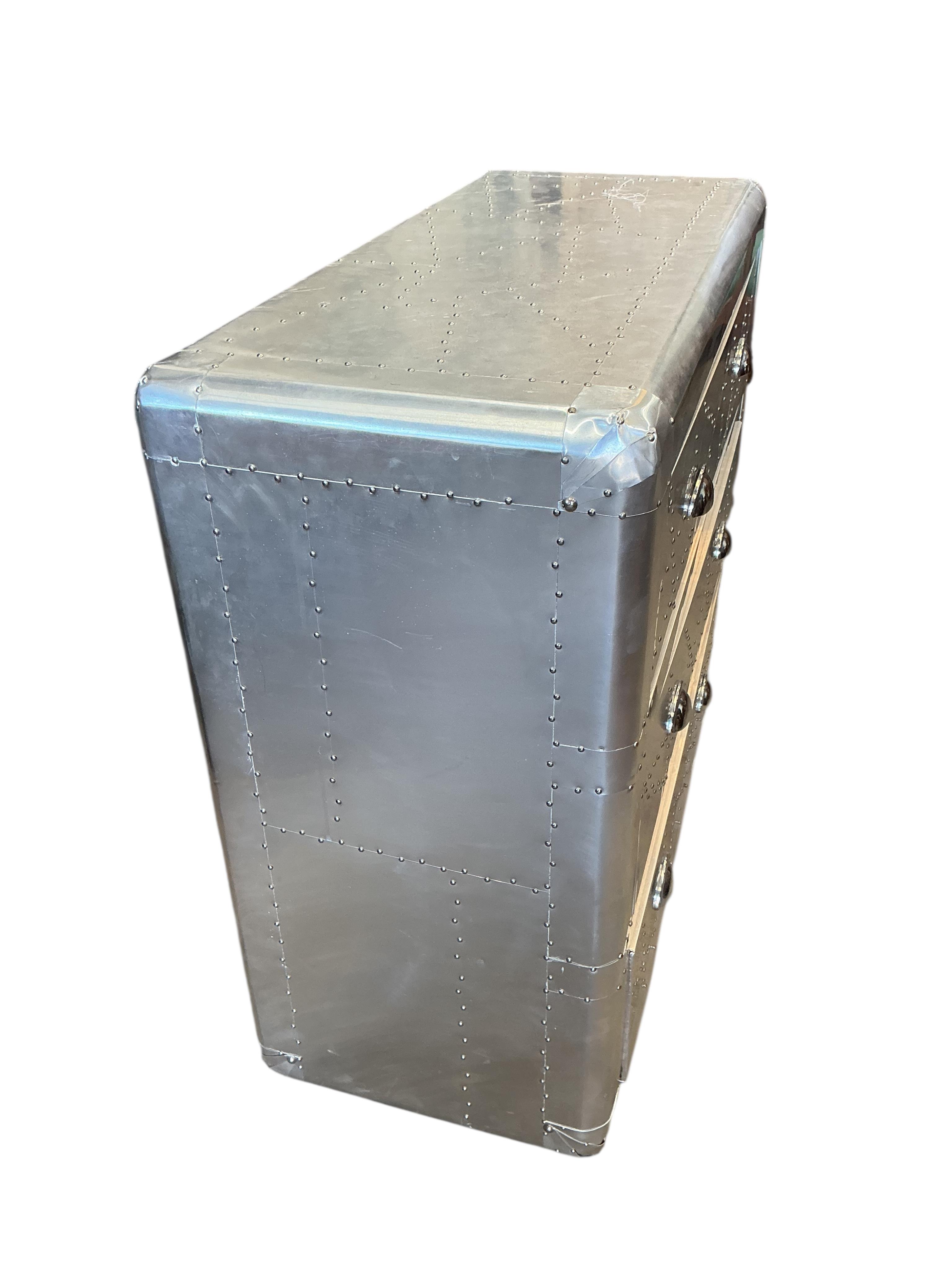 A pair of Contemporary aeronautical style aluminium mounted chest of three drawers, width 90cm, depth 38cm, height 79cm